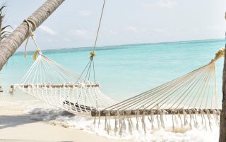 White polyester handwoven hammock by the beach